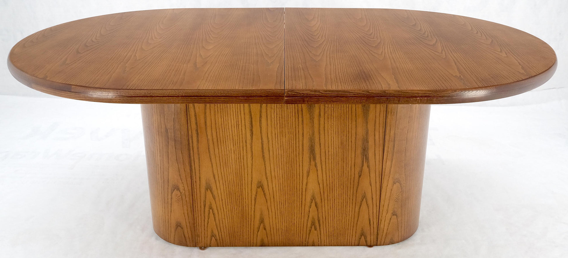 EstablishedLines Single Pedestal Base Oval racetrack Shape Two Leaves Cerused Oak Dining Table